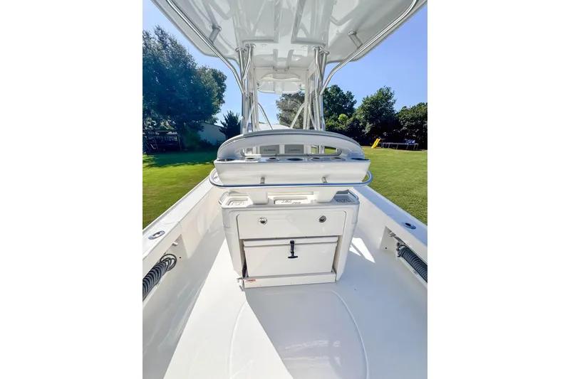Slide: The Image of 2026 SeaVee 270Z boat interior with console and seating, set against a grassy background. - 12