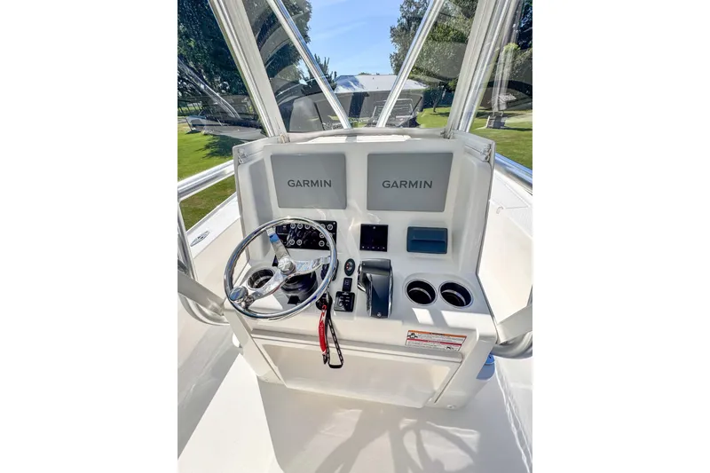 Slide: The Image of 2026 SeaVee 270Z boat console with Garmin displays and steering wheel. - 16