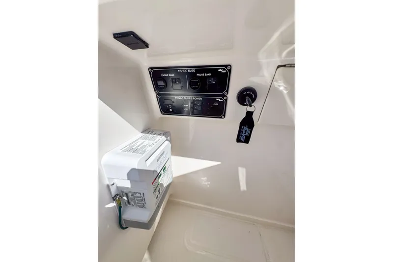 Slide: The Image of 2026 SeaVee 270Z boat control panel with key and electrical components. - 26