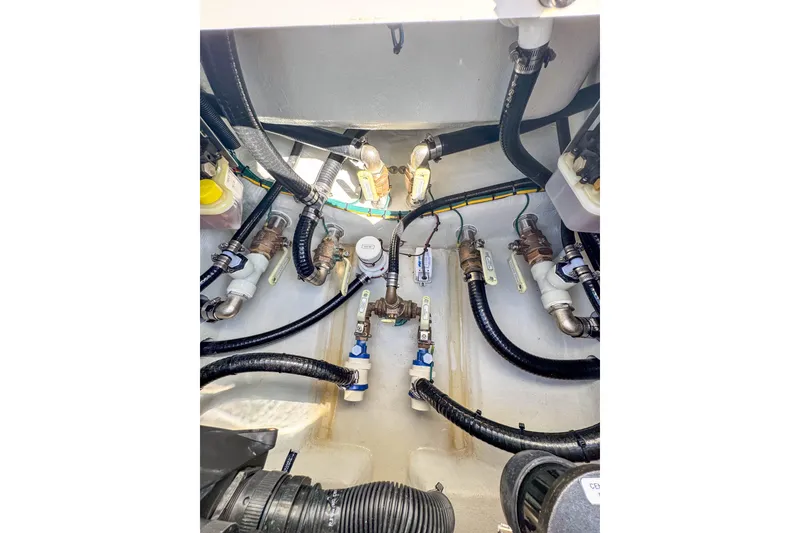Slide: The Image of Engine compartment of 2026 SeaVee 270Z boat, showcasing hoses and valves. - 27
