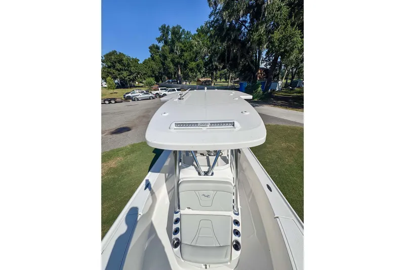 Slide: The Image of 2026 SeaVee 270Z boat with T-top and seating, parked outdoors. - 9