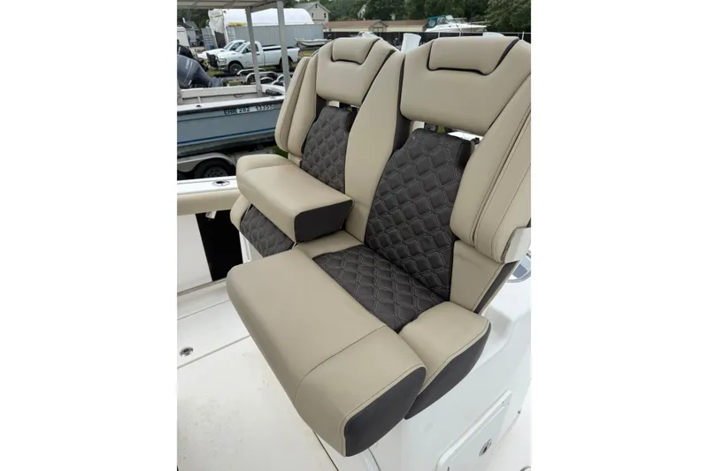 Slide: The Image of Luxurious seating on 2022 Tidewater 272 CC Adventure boat, featuring quilted upholstery. - 12