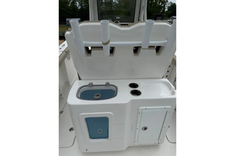 Slide: The Image of 2022 Tidewater 272 CC Adventure boat console with rod holders and storage compartments. - 6