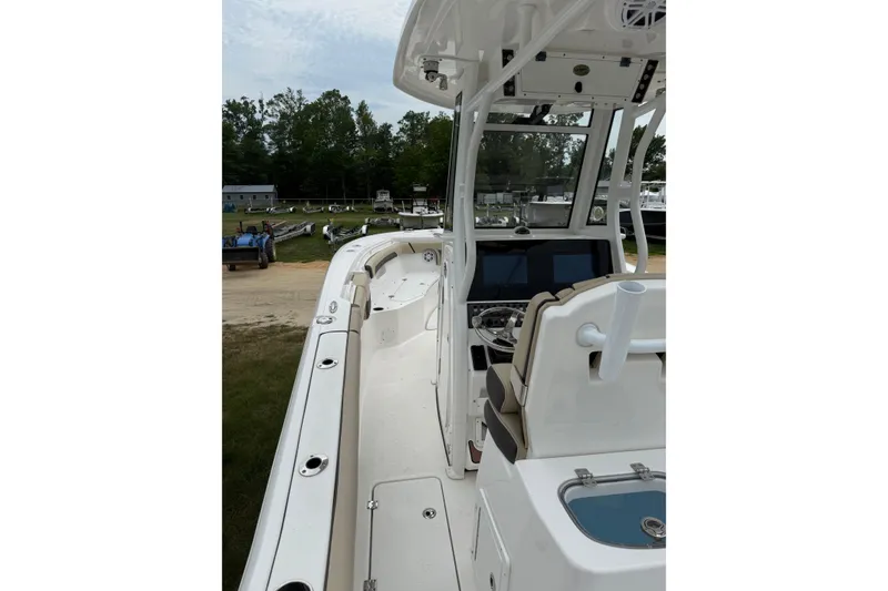 Slide: The Image of 2022 Tidewater 272 CC Adventure boat interior with helm and seating area. - 5