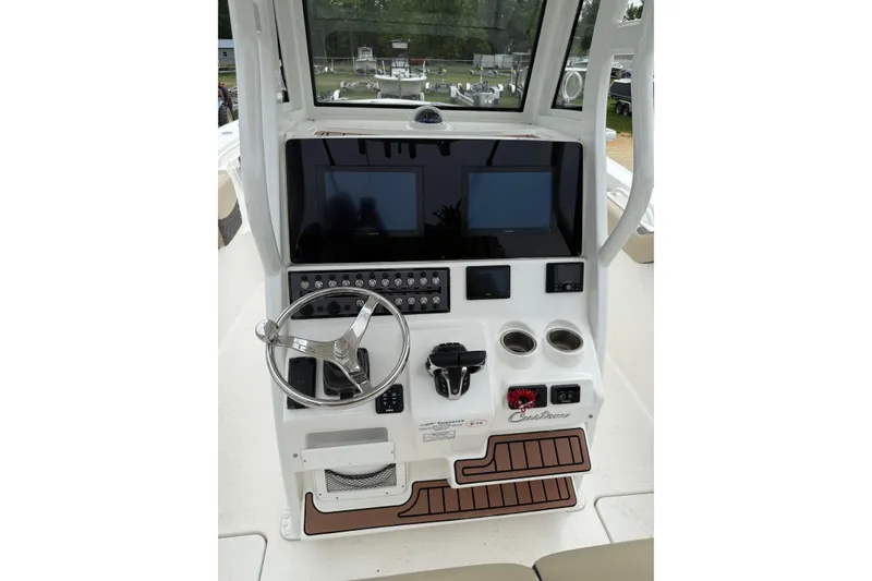 Slide: The Image of 2022 Tidewater 272 CC Adventure boat console with steering wheel and electronic displays. - 7
