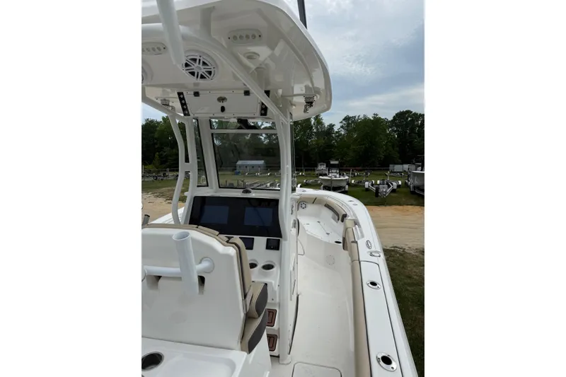 Slide: The Image of 2022 Tidewater 272 CC Adventure boat interior with helm and seating area. - 4