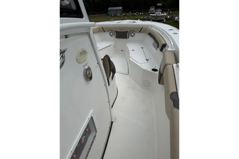 Slide: The Image of 2022 Tidewater 272 CC Adventure boat interior with seating and console. - 9