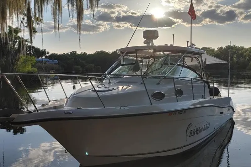 The Image of 2007 Seaswirl Striper 2901 Walkaround O/B boat on calm water at sunset. - 0