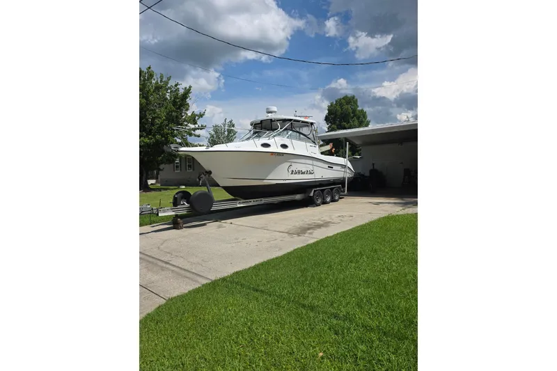 Slide: The Image of 2004 Seaswirl Striper 2901 Walkaround O/B boat on trailer in driveway. - 2