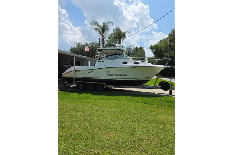 Slide: The Image of 2007 Seaswirl Striper 2901 Walkaround O/B boat on trailer, parked in a grassy yard. - 4