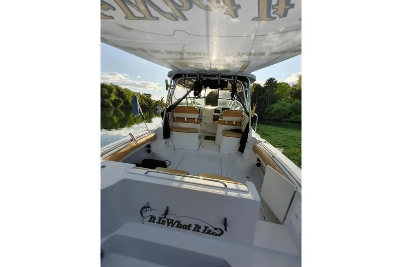 Slide: The Image of 2007 Seaswirl Striper 2901 Walkaround O/B boat interior with canopy, on a serene river. - 6