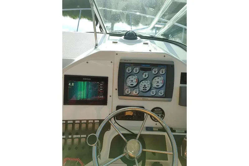 Slide: The Image of 2007 Seaswirl Striper 2901 Walkaround O/B helm with Simrad and Garmin displays. - 8