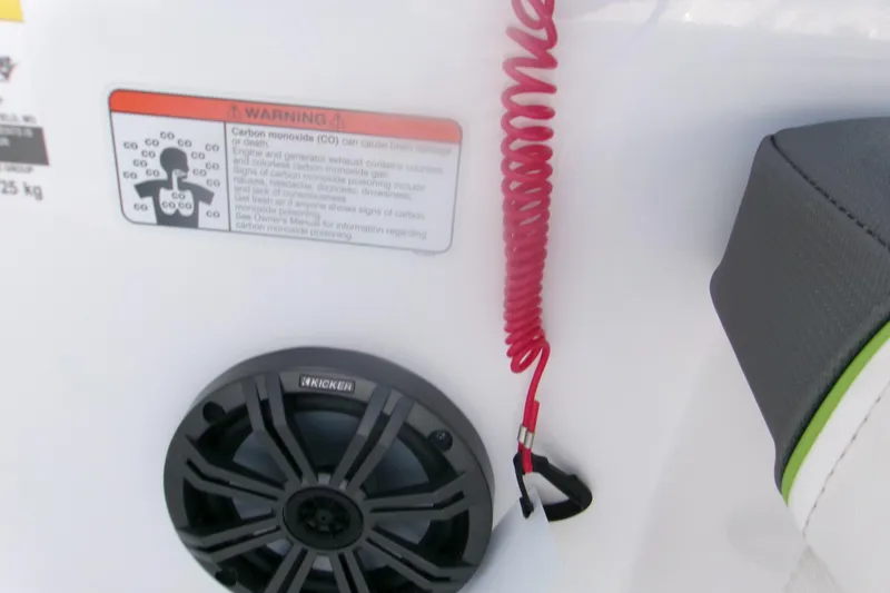 Slide: The Image of 2024 Tahoe T16 boat interior with warning label, speaker, and red safety cord. - 10