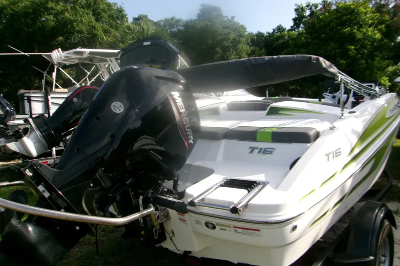 Slide: The Image of 2024 Tahoe T16 boat with Mercury outboard motor, parked outdoors. - 2