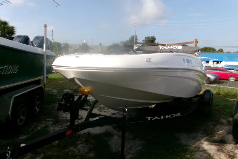 Slide: The Image of 2024 Tahoe T16 boat on trailer, parked outdoors under a clear sky. - 3