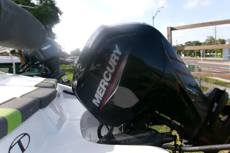 Slide: The Image of 2024 Tahoe T16 boat with Mercury outboard motor in a sunny outdoor setting. - 4