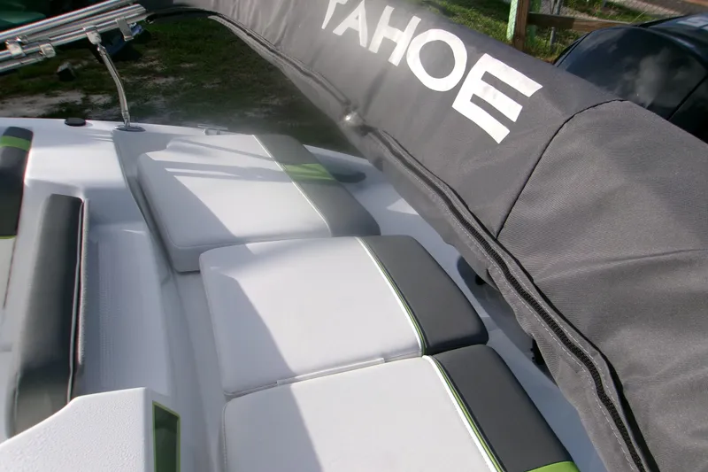 Slide: The Image of 2024 Tahoe T16 boat interior with cushioned seating and protective cover. - 6