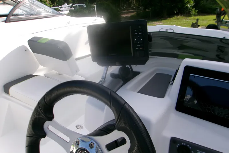 Slide: The Image of 2024 Tahoe T16 boat dashboard with steering wheel and navigation screens. - 8