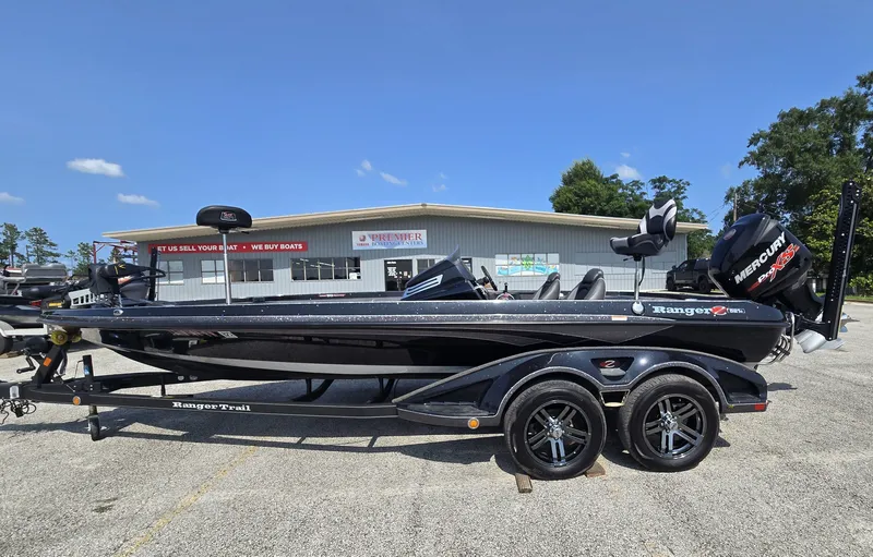 The Image of A black Ranger Z521 Comanche boat on a trailer in front of a building. - 1