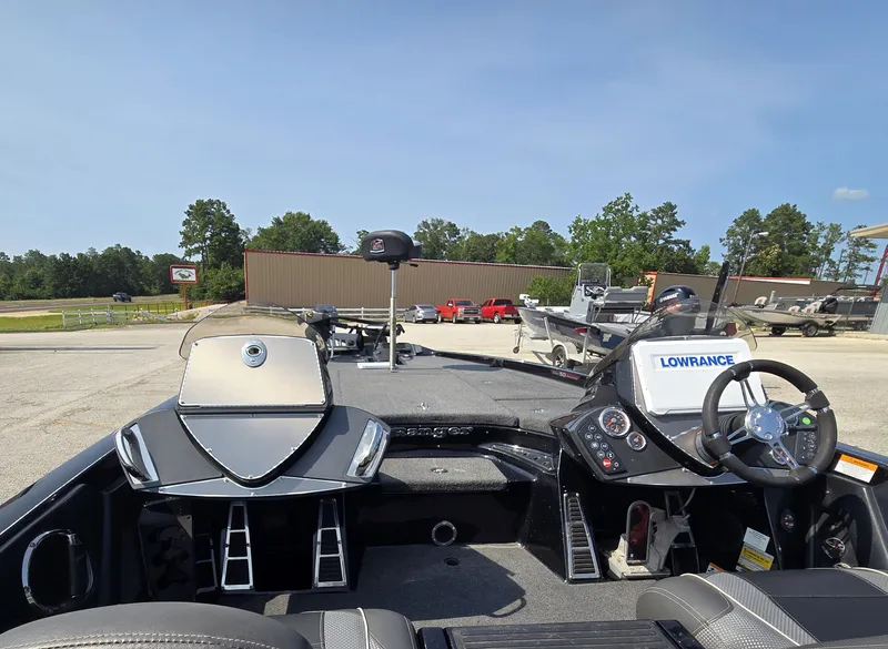 Slide: The Image of The image shows the cockpit of a Ranger Z521 Comanche boat with steering and electronics. - 13