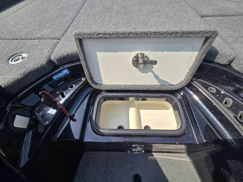 Slide: The Image of An open storage compartment on a 2018 Ranger Z521 Comanche boat. - 14