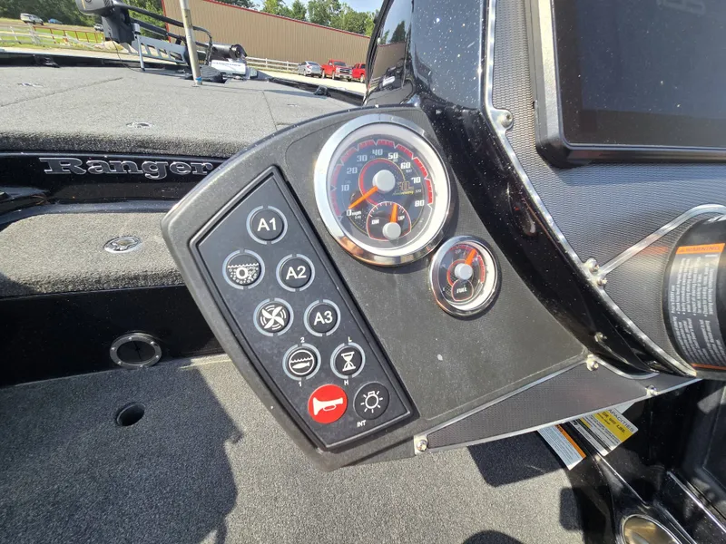 Slide: The Image of Close-up of a Ranger Z521 Comanche boat dashboard with various gauges and switches. - 17