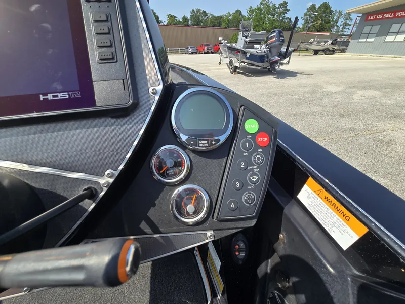 Slide: The Image of Close-up of the control area of a Ranger Z521 Comanche boat with instruments and controls. - 18