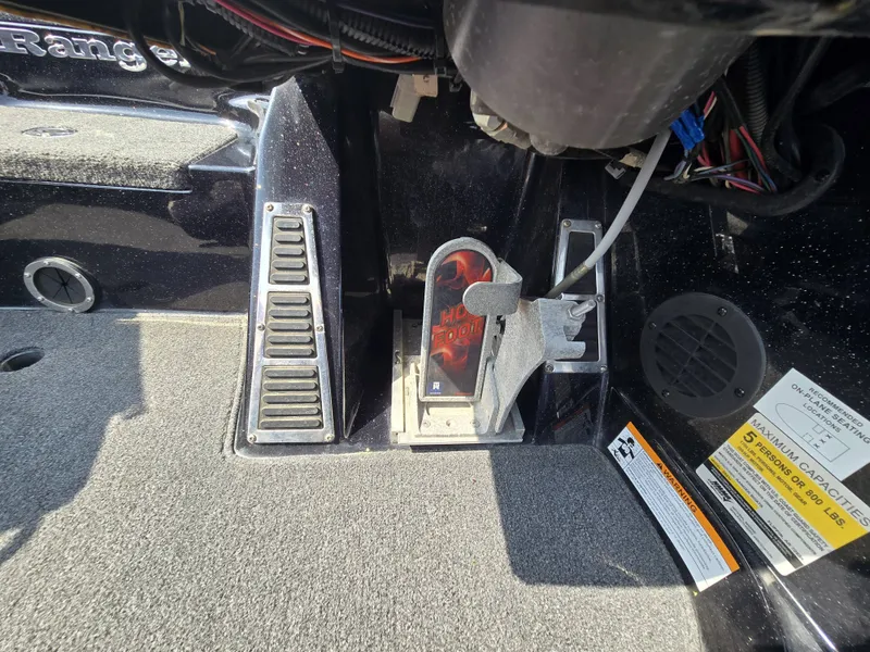 Slide: The Image of Close-up of a Ranger Z521 Comanche boat interior with pedals and wiring. - 19