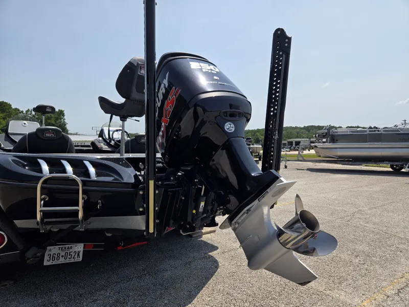 Slide: The Image of A 2018 Ranger Z521 Comanche with a powerful outboard motor, parked in a lot. - 6