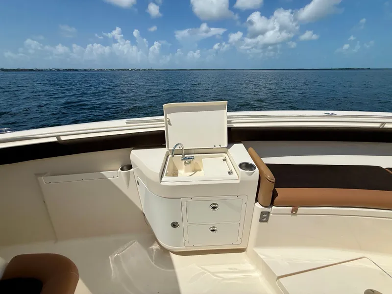 Slide: The Image of The image shows the deck of a 2014 Scout 320 LXF boat with a sink. - 11
