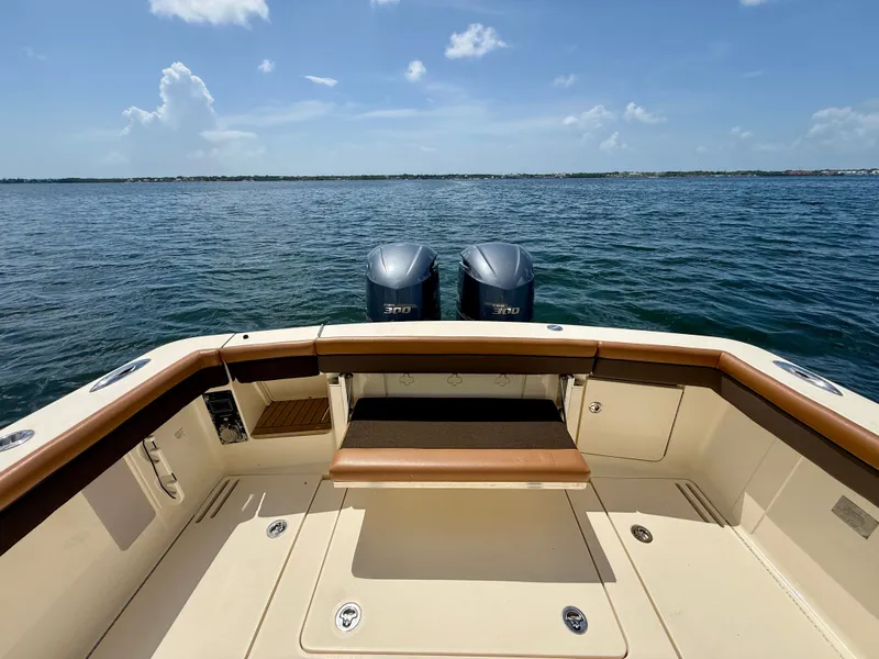Slide: The Image of The image shows the stern of a Scout 320 LXF boat on the water. - 15