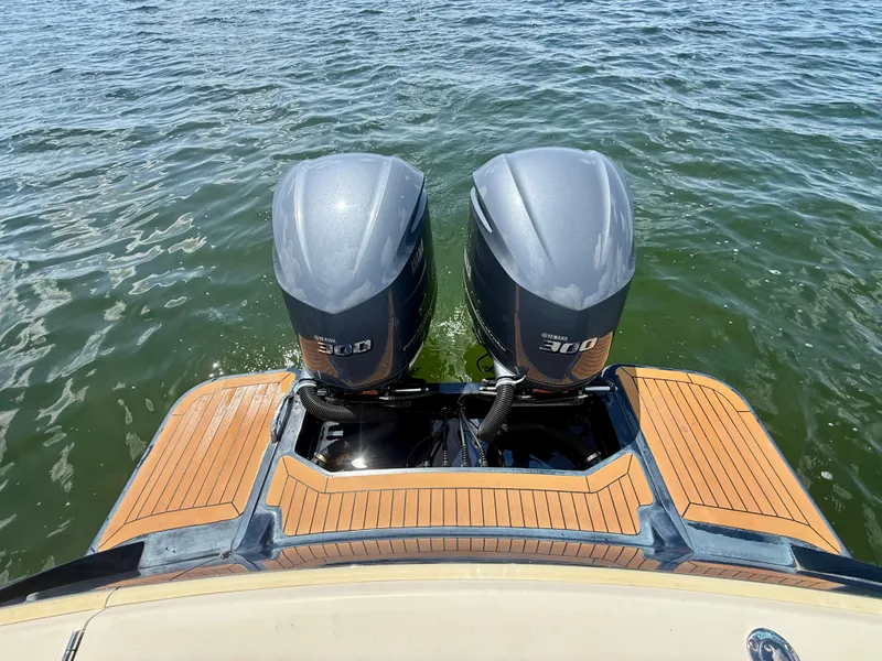 Slide: The Image of Two outboard engines on a boat in the water, with a wooden deck. - 19