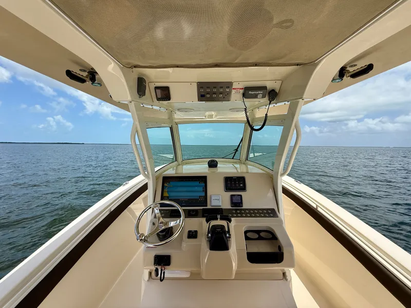 Slide: The Image of The cockpit of a 2014 Scout 320 LXF with modern helm and electronics on open water. - 3