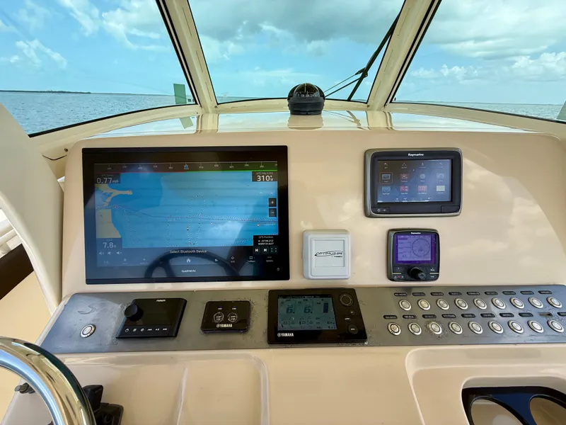 Slide: The Image of The image shows the dashboard of a Scout 320 LXF boat with modern navigation equipment. - 4