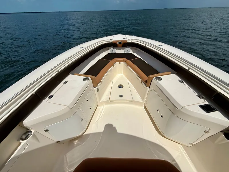 Slide: The Image of The image shows the bow of a Scout 320 LXF boat on the water. - 8