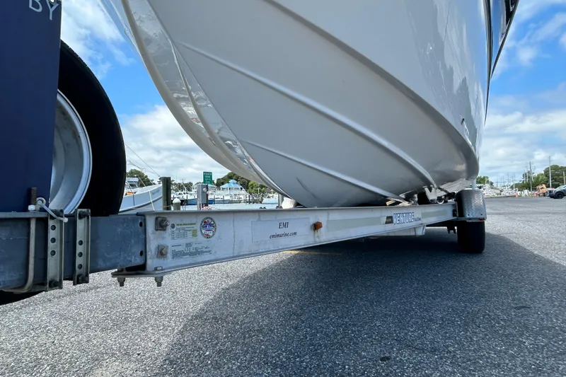 Slide: The Image of 2018 Sea Fox 266 Commander boat on trailer, parked in marina under blue sky. - 4