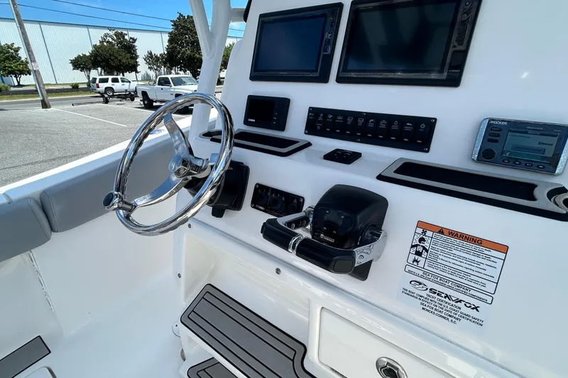 Slide: The Image of 2018 Sea Fox 266 Commander boat dashboard with steering wheel and electronic controls. - 19