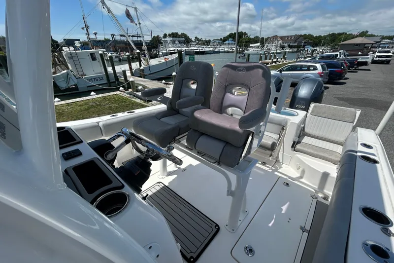 Slide: The Image of 2018 Sea Fox 266 Commander boat interior with dual captain's chairs and control panel. - 14