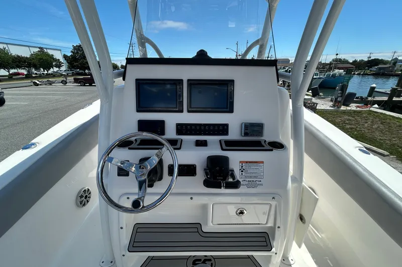 Slide: The Image of 2018 Sea Fox 266 Commander boat dashboard with dual screens and steering wheel. - 15