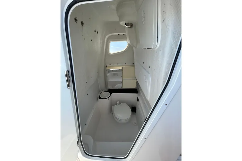 Slide: The Image of 2018 Sea Fox 266 Commander boat interior with compact marine toilet and storage. - 22