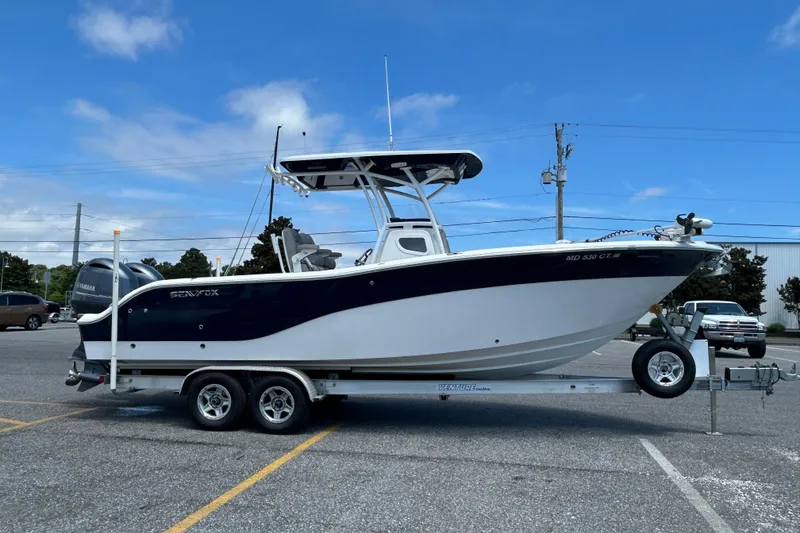 Slide: The Image of 2018 Sea Fox 266 Commander boat on trailer in parking lot under blue sky. - 5