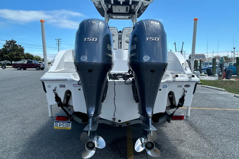 Slide: The Image of 2018 Sea Fox 266 Commander with twin Yamaha 150 engines, parked in a marina. - 8