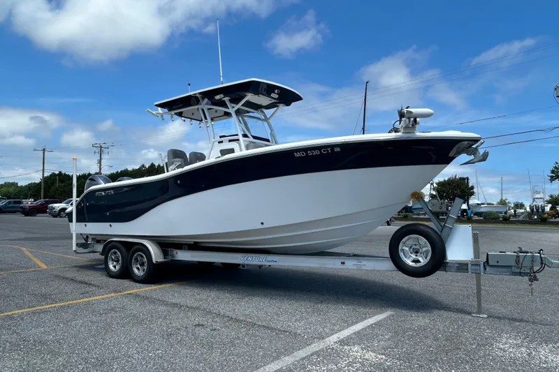 Slide: The Image of 2018 Sea Fox 266 Commander boat on trailer in parking lot under blue sky. - 6