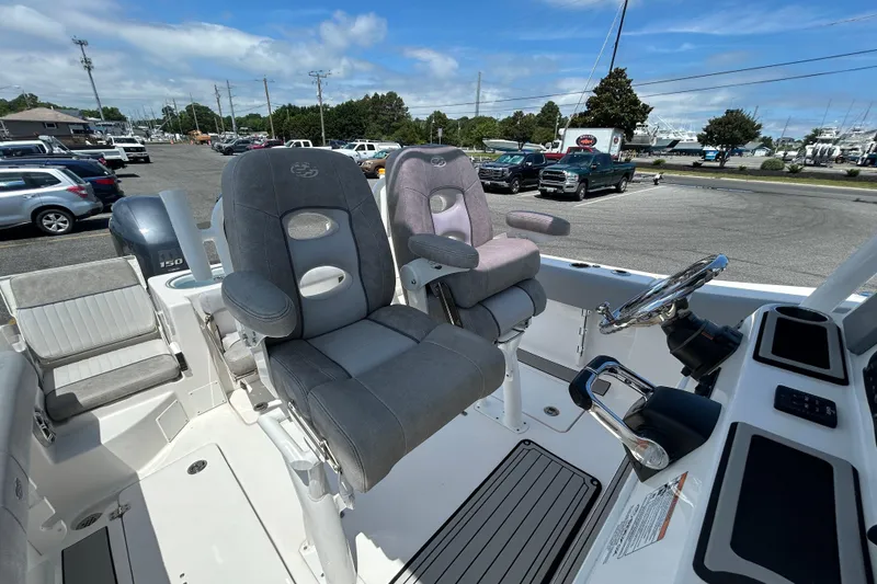 Slide: The Image of 2018 Sea Fox 266 Commander boat interior with dual captain's chairs and steering console. - 18