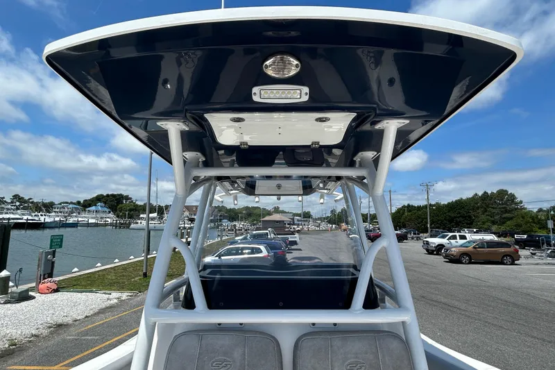 Slide: The Image of 2018 Sea Fox 266 Commander boat at marina, showcasing T-top and seating. - 20
