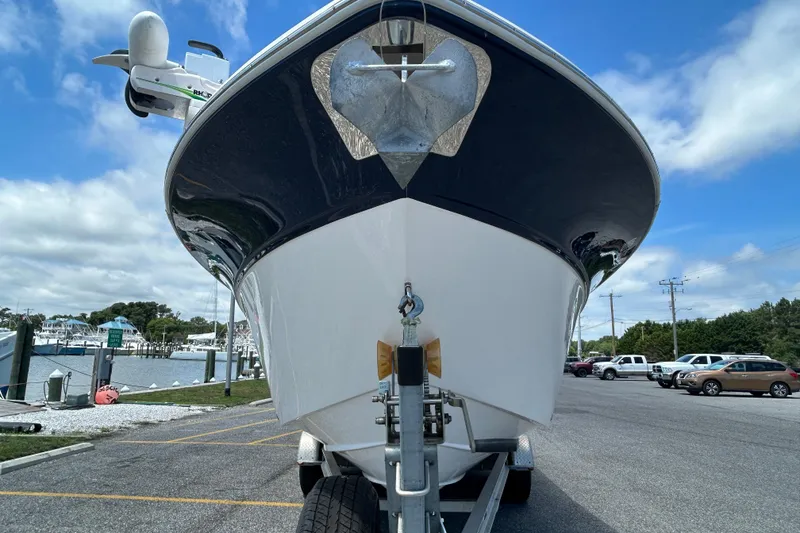 Slide: The Image of 2018 Sea Fox 266 Commander boat on trailer at marina under blue sky. - 3