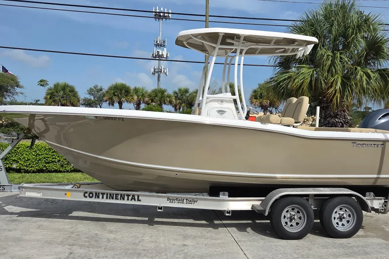 The Image of 2015 Tidewater 220 LXF boat on trailer, parked outdoors with palm trees in background. - 0