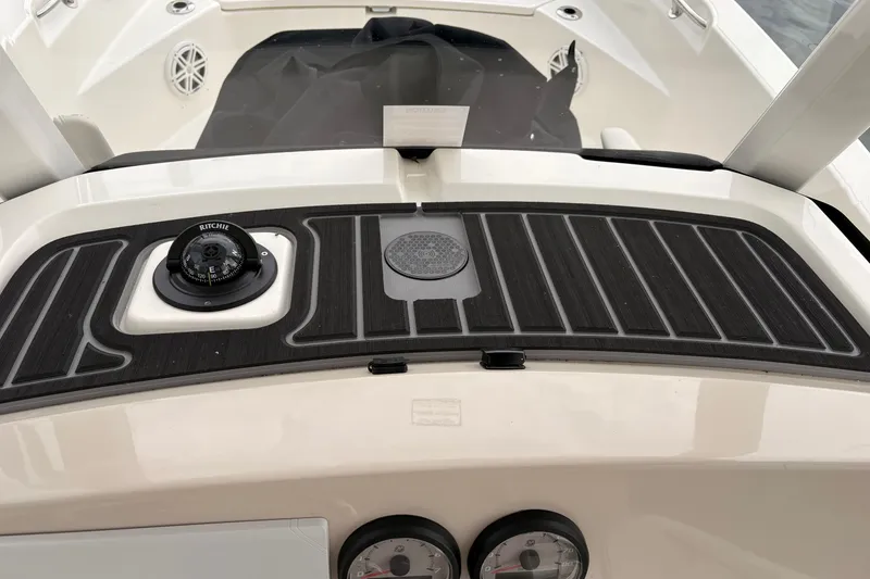 Slide: The Image of 2026 Boston Whaler 22 Dauntless dashboard with compass and gauges. - 10