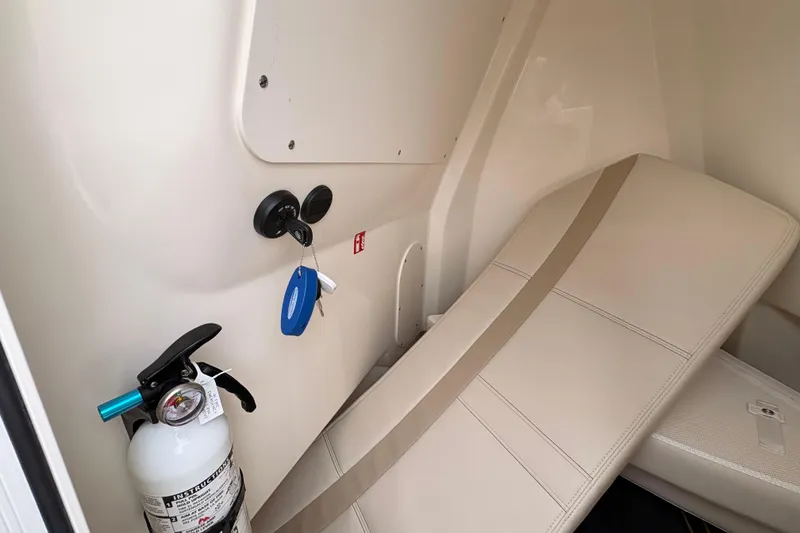 Slide: The Image of Interior of 2026 Boston Whaler 22 Dauntless with fire extinguisher and keys. - 12