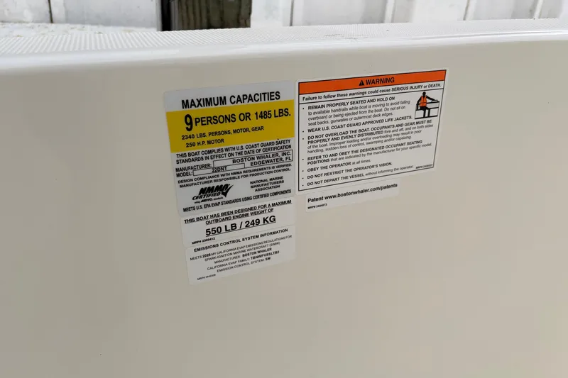 Slide: The Image of Safety label on 2026 Boston Whaler 22 Dauntless, detailing maximum capacities and warnings. - 14